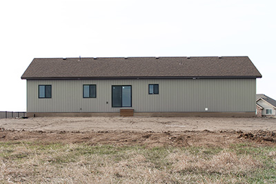 Custom home back exterior with large backyard