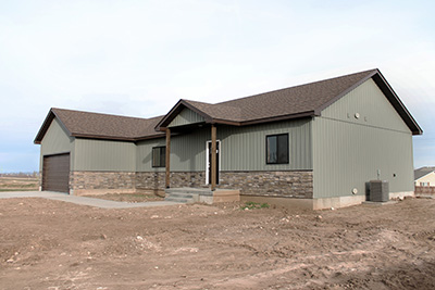 Custom home exterior with front step and dark accent door