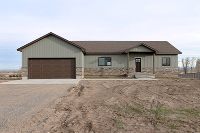 Custom home exterior with vinyl siding and stone accent