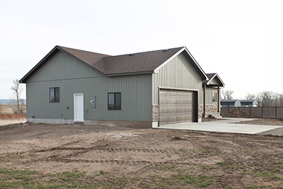 Custom home exterior garage door that matches the front door color
