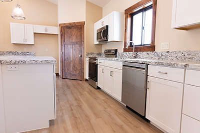 Custom home kitchen with granite countertops and soft-close cabinetry