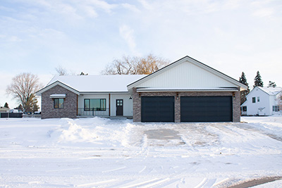 Custom home exterior with vinyl siding and stone accent